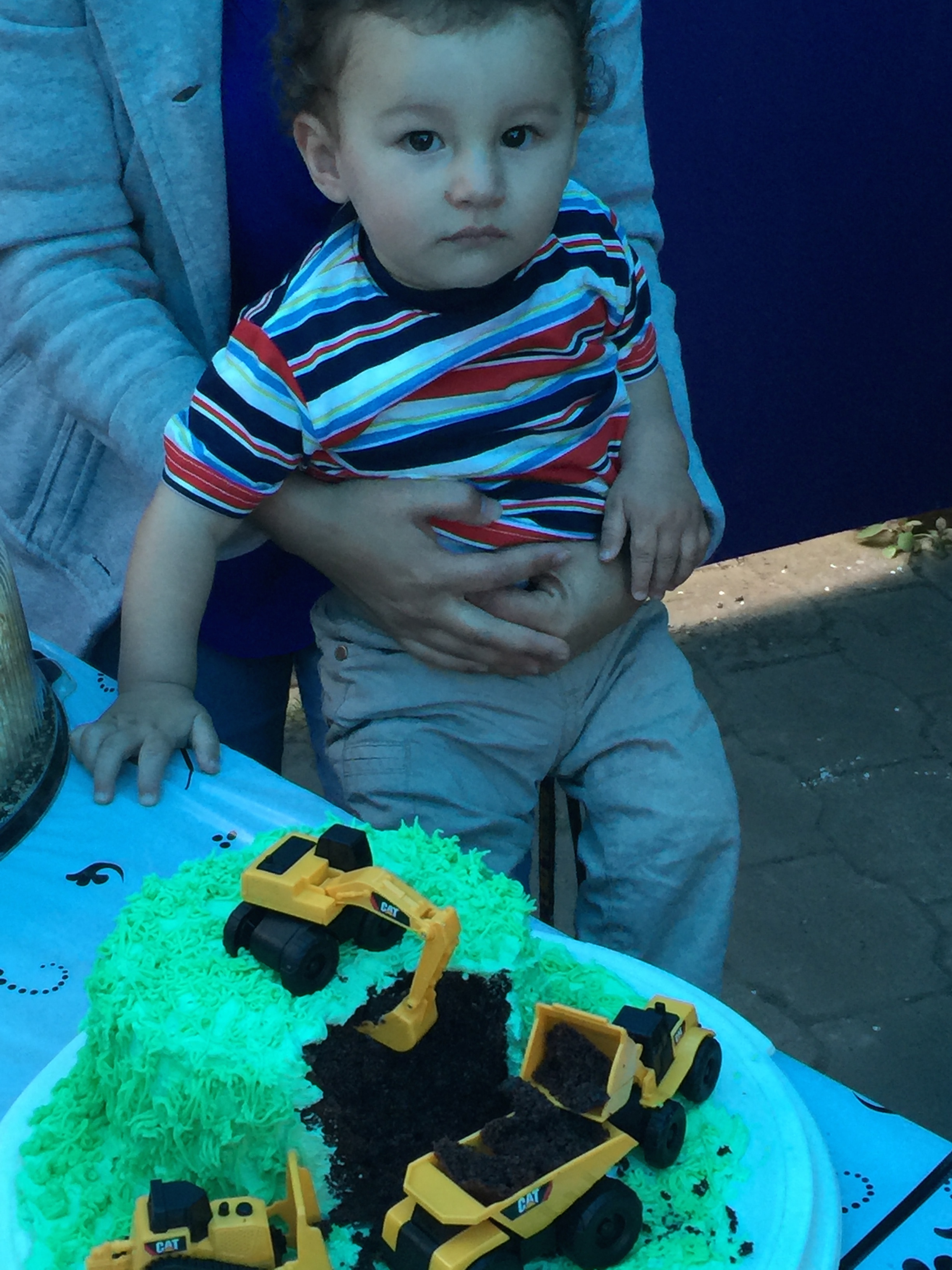 Our grandson, Robbie, and his 1st birthday cake. A construction site!